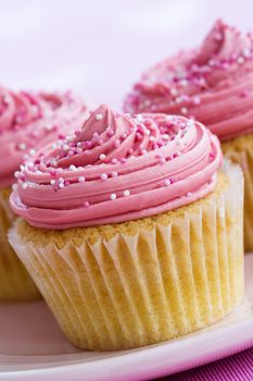 Cupcakes decorated with pink frosting and sprinkles