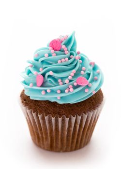 Chocolate cupcake decorated with blue frosting and pink sugar sprinkles
