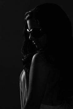 Low key portrait of woman with sunglasses