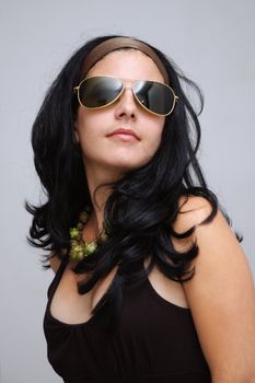 Portrait of trendy hispanic female wearing fashion sunglasses