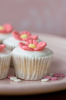 Mini cupcakes decorated with pink sugar flowers