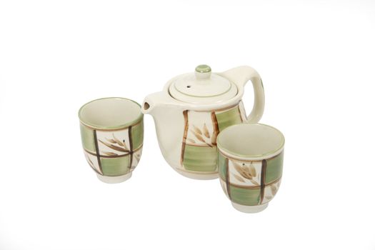 One porcelain decorated teapot and two teacups on white background. Clipping path included.