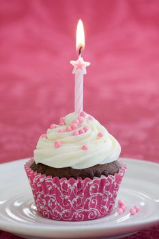 Mini birthday cake decorated with a single candle
