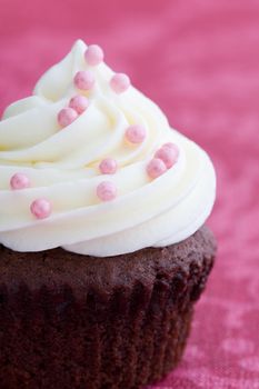 Chocolate cupcake decorated with pink dragees