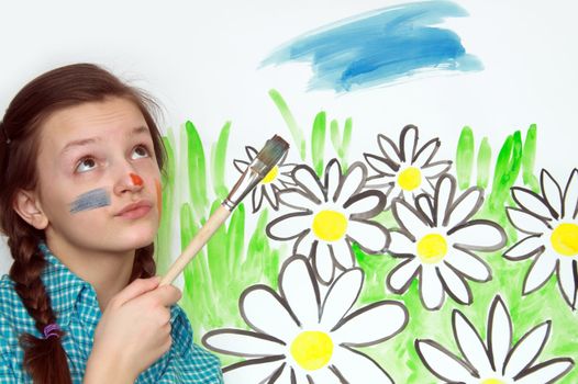 Young nice girl with brush on background with painted flowers