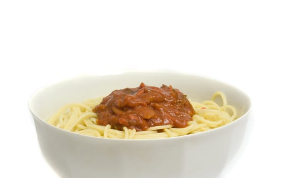 close-up on a full bowl of pasta with meat, vegetables, sauce, spices and cheese