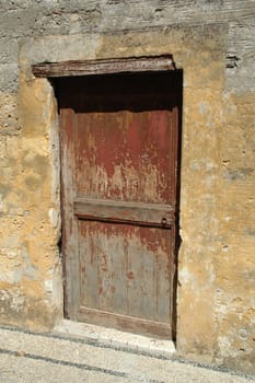 Wooden door. The door is old and red.