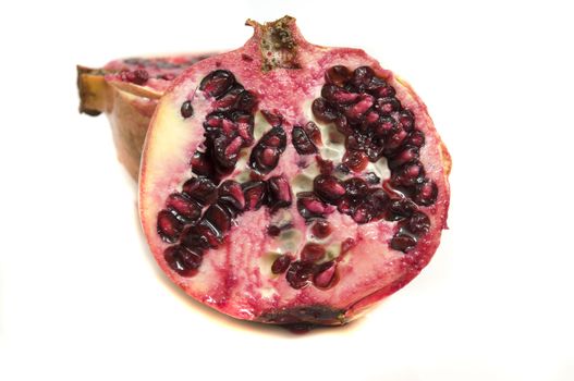 Close-up on a fresh pomegranate section, isolated on white