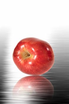 Red apple on the polished surface