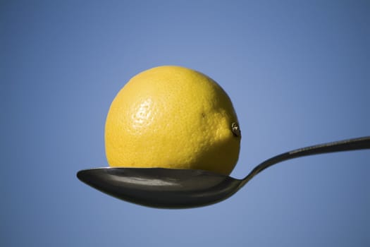 lemon and spoon against blue sky