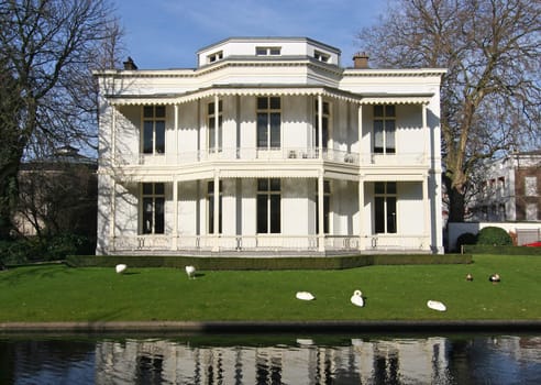 Classical white villa with swans