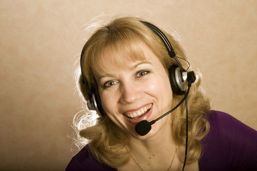 Smiling phone operator young woman in a call center 