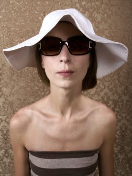 Young Woman with Sunglasses and a Floppy White Hat