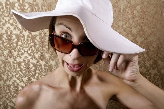 Young Woman with Sunglasses and a Floppy White Hat