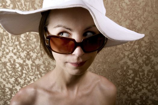 Young Woman with Sunglasses and a Floppy White Hat
