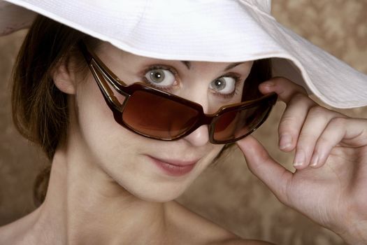 Young Woman with Sunglasses and a Floppy White Hat