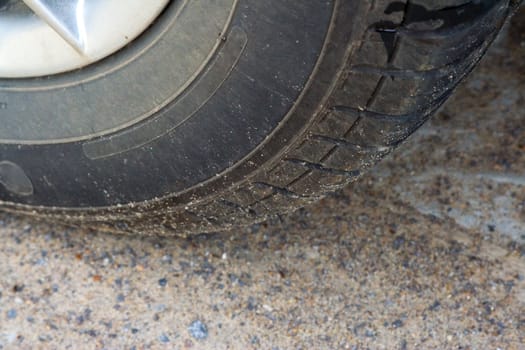 fragment of a car wheel on a gravel. close-up