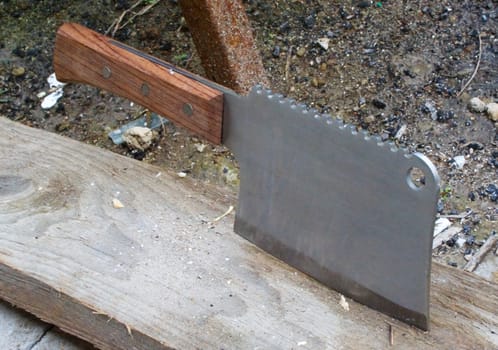 New shiny kitchen axe embedded in wooden plank