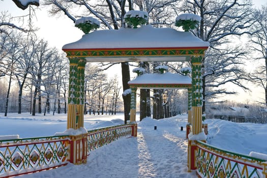 Multicolored Chinese bridge in winter park
