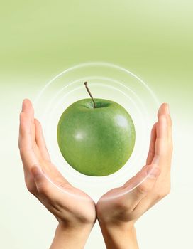 Combination with hand and a green apple