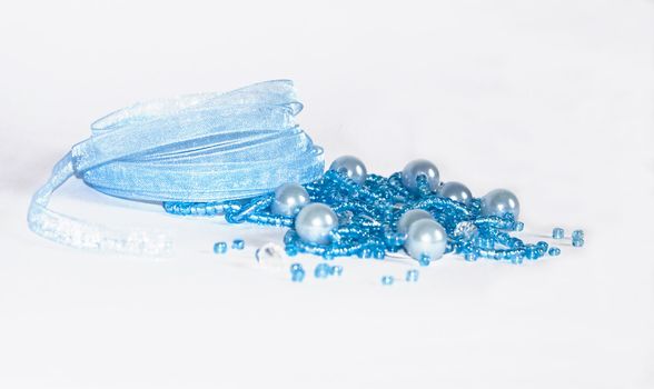 The image of the torn beads and a kapron tape on a white background