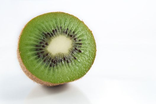 Close, low level of half a kiwifruit isolated over white.