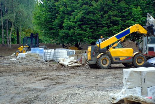 A photograph of a building site with numerous examples of heavy machinery.