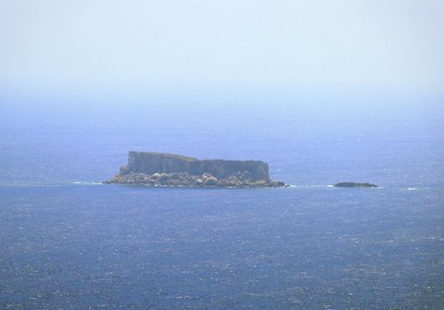 Filfla is a small, barren, uninhabited islet 5 km south of Malta. The image is taken from Dingli Cliffs, at 7,5km distance.
