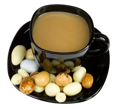 close-up black cup of coffee with milk and candies, isolated on white