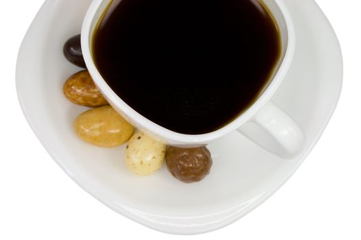 close-up cup of coffee with candies, isolated on white