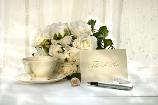 Writing invitation card with pen and a cup of tea