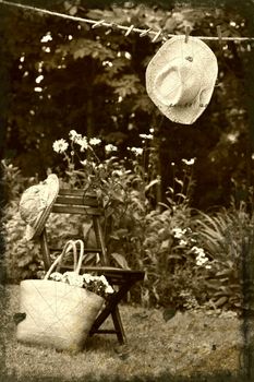 Straw hat hanging on clothesline in the garden/ Sepia tone