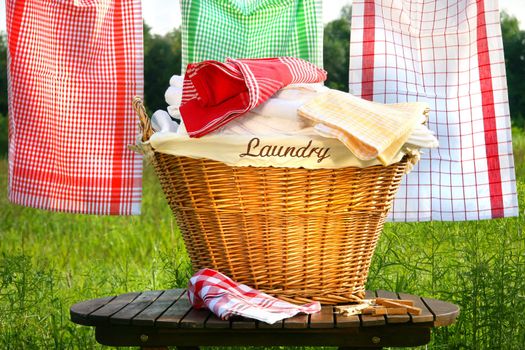 Laundry basket on rustic table with clothesline