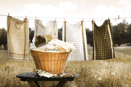 Towels drying on the clothesline with laundry basket/ Sepia tone