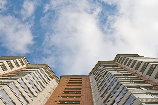 A residential multistory house and sky, view from below