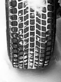 Mud and snow tire tread packed with snow