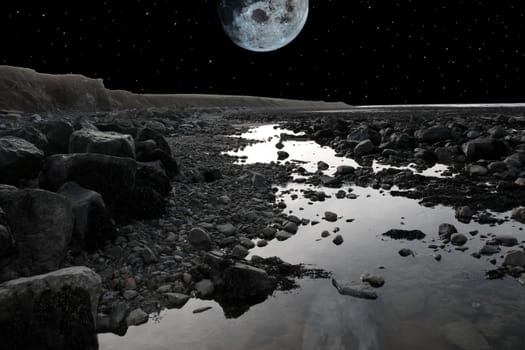 grey boulders and rocks on beale beach co kerry ireland on a cold winters night under a full moon