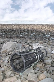 a lobster pot on a rocky irish beach