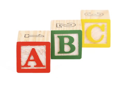 Alphabet blocks lined up to spell abc - isolated on white - focus on A block