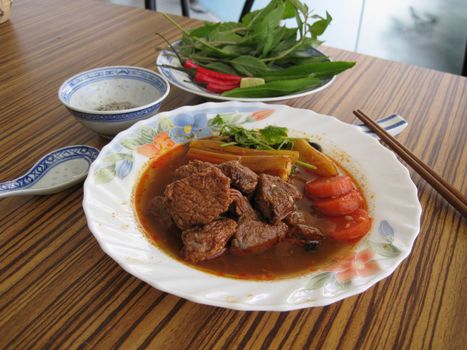 serving a plate of beef stewed