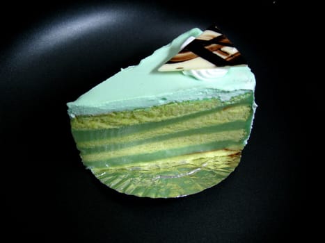 a piece of creamy layer cake with white chocolate on top