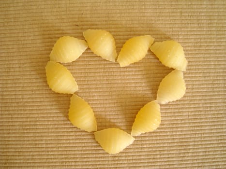 top view of a love shape made by pasta shell