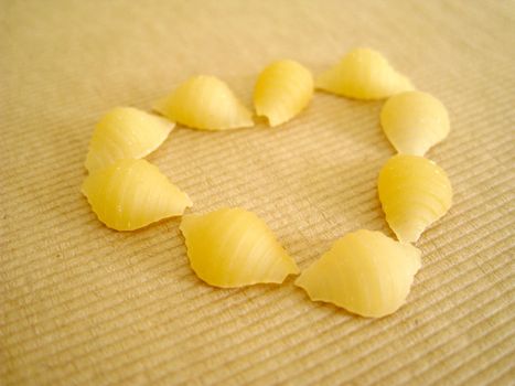 a love shape made by 9 pcs of pasta shell