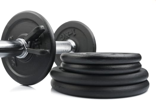 Stack of black weights on a white background. Horizontal shot.