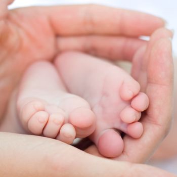 Mother holding her child's feet