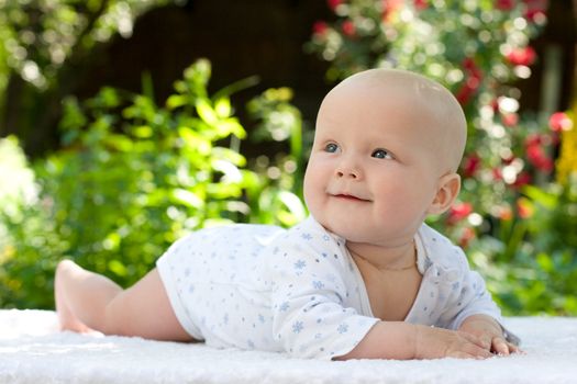 Little baby enjoying summer in a garden