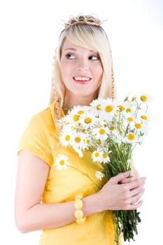 Cute girl with bunch of camomilles on isolated background