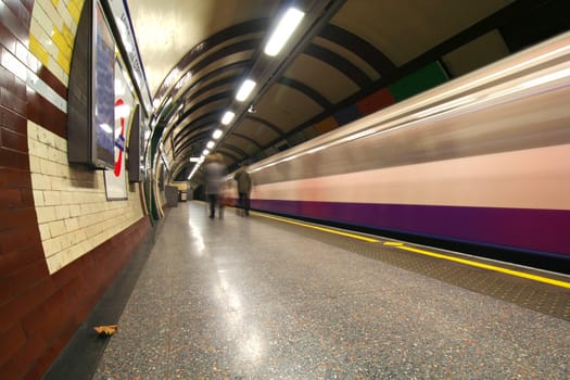Subway train rushing by the station