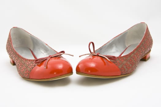 pair of red woman shoes on white background