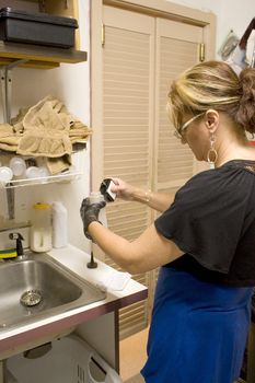 A hairdresser mixing a hair color formula in the back room.